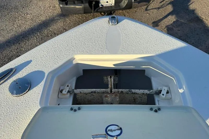 Slide: The Image of 2019 NauticStar 25 XS boat anchor compartment with open hatch. - 31