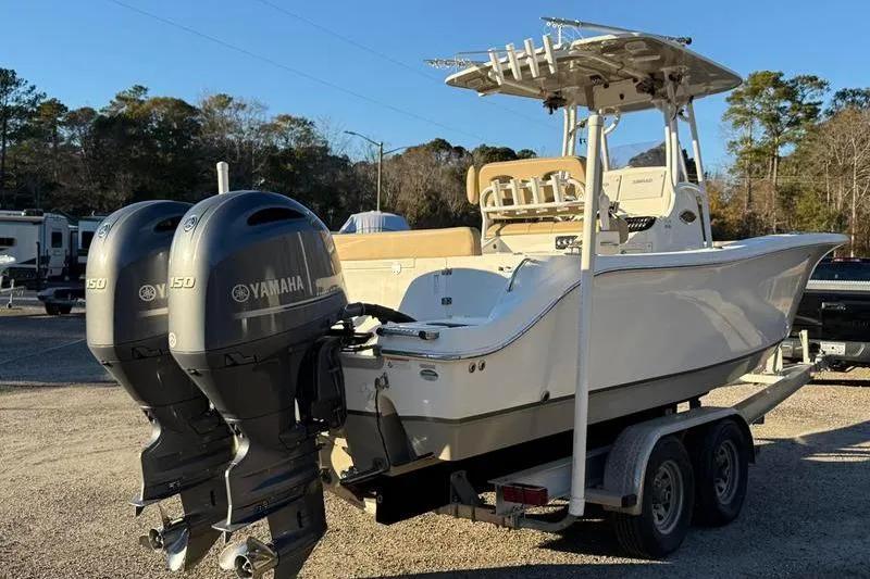 Slide: The Image of 2019 NauticStar 25 XS boat with dual Yamaha engines on a trailer. - 4