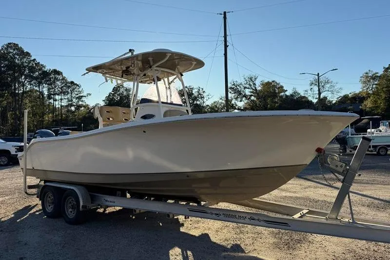 Slide: The Image of 2019 NauticStar 25 XS boat on trailer in outdoor setting. - 6