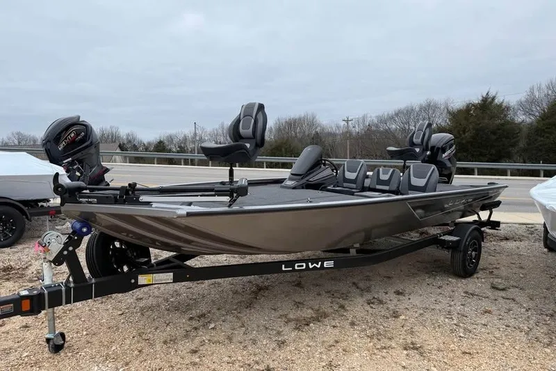 Slide: The Image of 2026 Lowe Stinger 195 Bass boat on trailer, featuring sleek design and modern seating. - 3