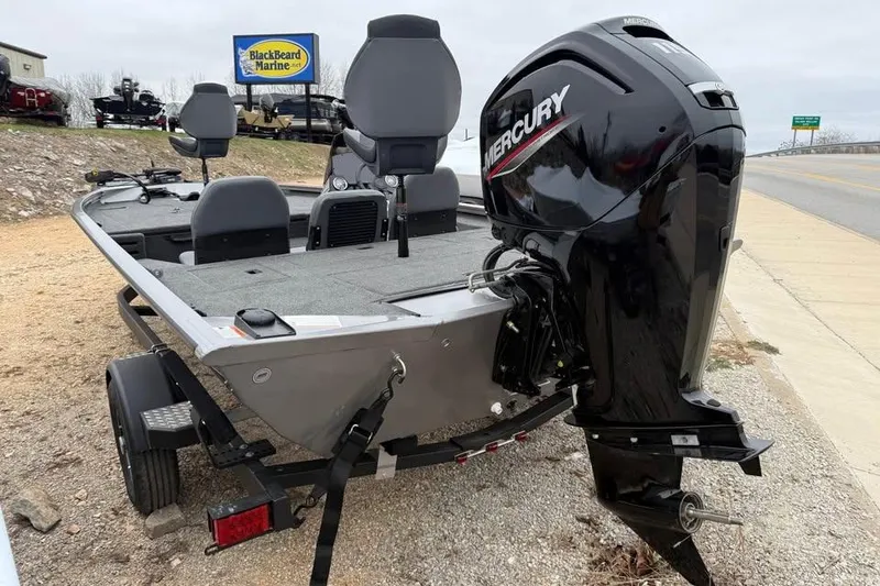 Slide: The Image of 2026 Lowe Stinger 195 Bass boat with Mercury engine, parked on a trailer. - 4