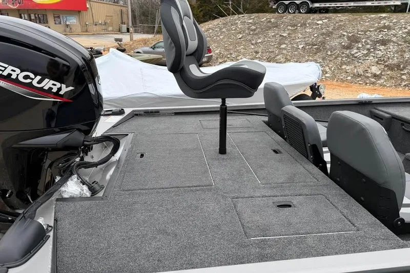 Slide: The Image of 2026 Lowe Stinger 195 Bass boat interior with Mercury engine and seating. - 7