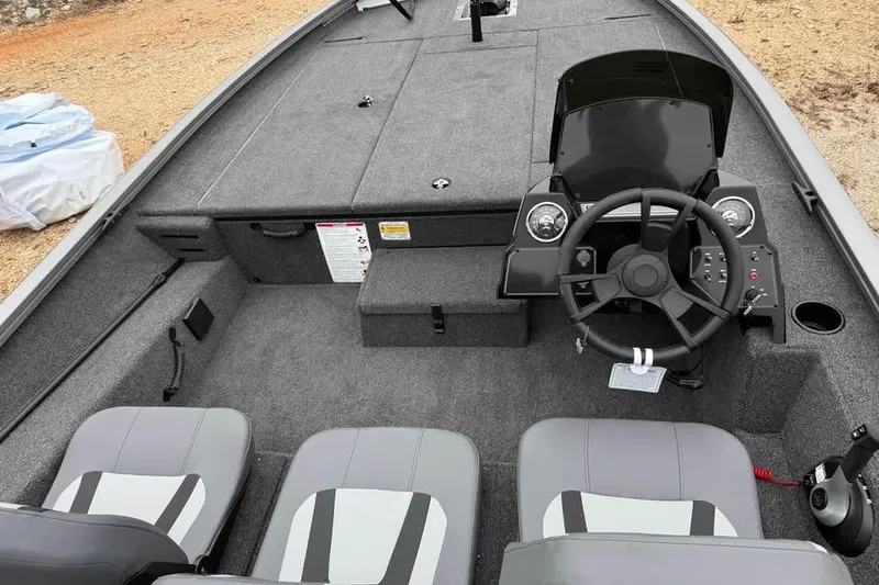 Slide: The Image of 2026 Lowe Stinger 195 Bass boat interior with steering console and seating. - 8