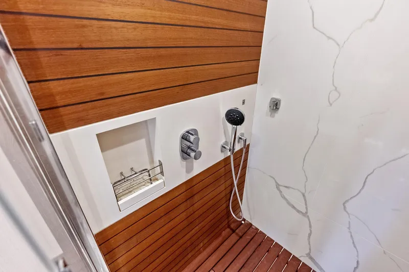 Slide: The Image of Luxurious shower in 2021 Azimut Fly 78 yacht with wood paneling and modern fixtures. - 101