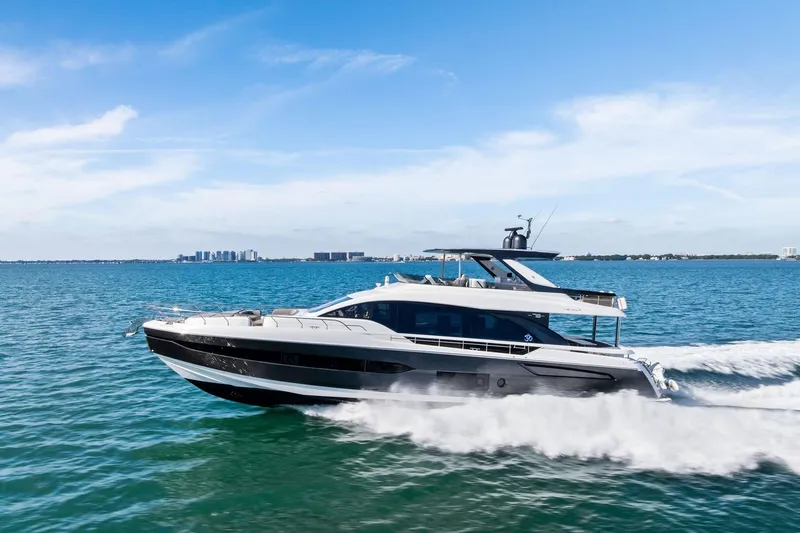 Slide: The Image of 2021 Azimut Fly 78 yacht cruising on open water under a clear blue sky. - 16