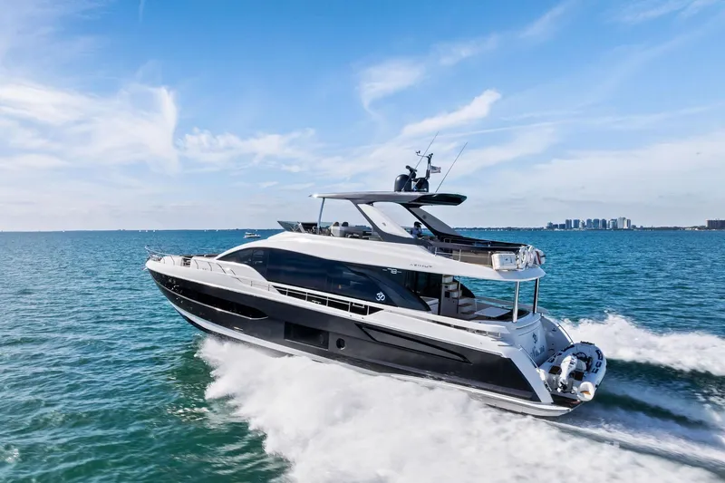 Slide: The Image of 2021 Azimut Fly 78 yacht cruising on open water under a clear blue sky. - 19