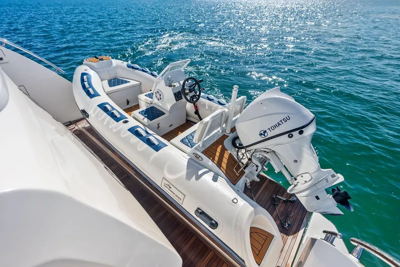 Slide: The Image of 2021 Azimut Fly 78 yacht with Tohatsu motor, docked on clear blue water. - 33