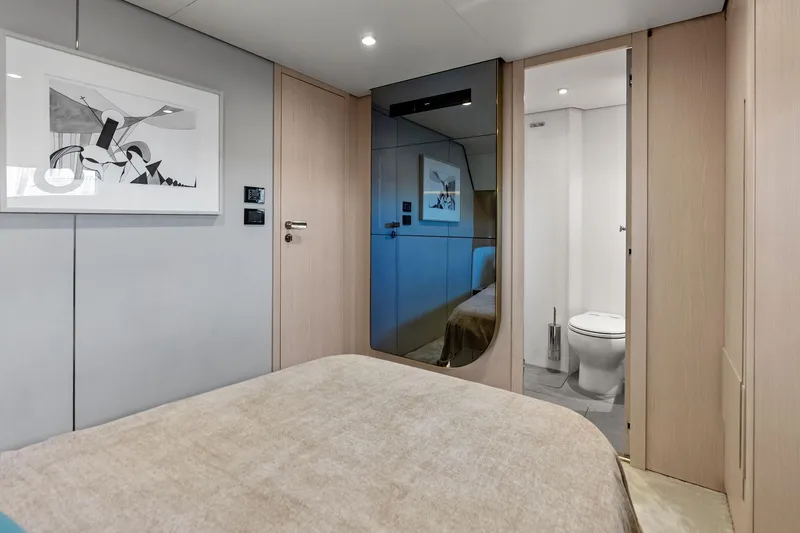 Slide: The Image of Luxurious interior of 2021 Azimut Fly 78 yacht bedroom with modern decor and ensuite bathroom. - 78