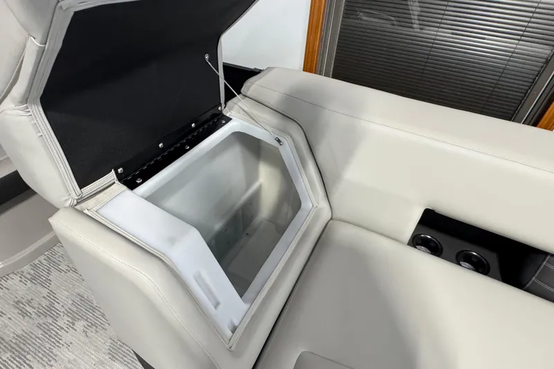 Slide: The Image of 2026 Sylvan G5 CLZ boat seat with open storage compartment and cup holders. - 13