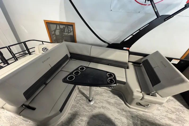 Slide: The Image of 2026 Sylvan G5 CLZ boat interior with gray seating and a central table. - 18