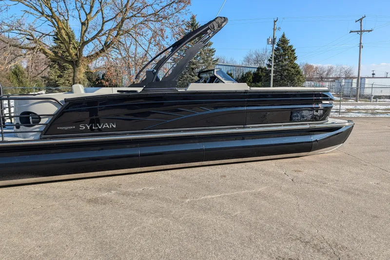 Slide: The Image of 2026 Sylvan G5 CLZ pontoon boat parked outdoors on a sunny day. - 2