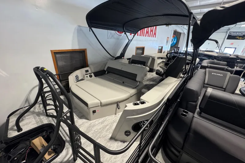 Slide: The Image of 2026 Sylvan G5 CLZ boat interior with seating and canopy in showroom. - 21
