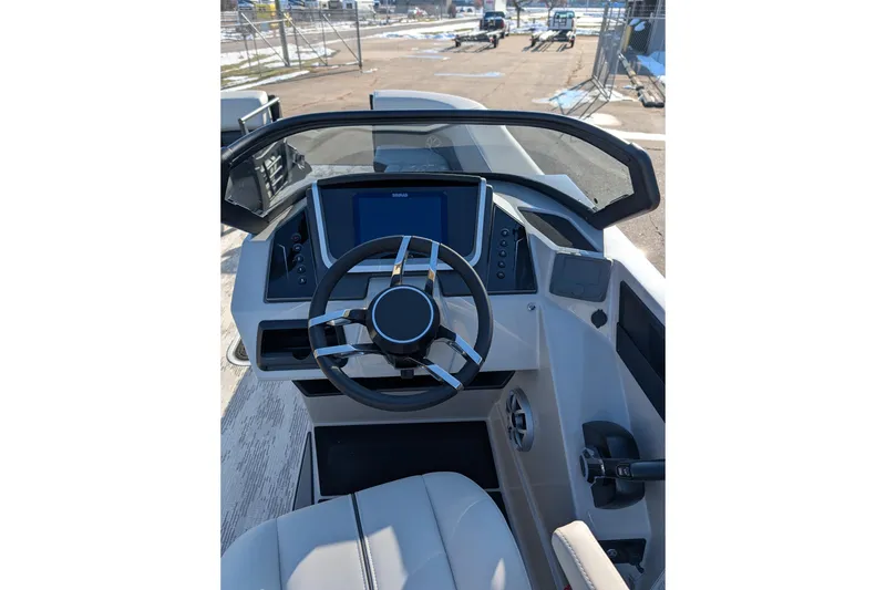 Slide: The Image of 2026 Sylvan G5 CLZ boat dashboard with steering wheel and digital display. - 8