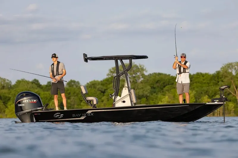 Slide: The Image of Manufacturer Provided Image: Two people fishing on a 2026 G3 Bay 19 GX boat in a scenic lake. - 2