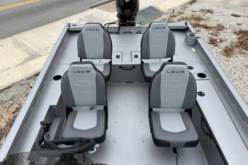 Slide: The Image of 2026 Lowe Outlet 20 boat interior with four gray seats and steering console. - 12
