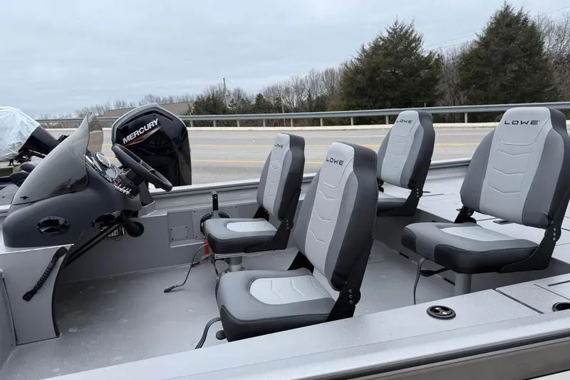 Slide: The Image of 2026 Lowe Outlet 20 boat interior with four gray seats and Mercury engine. - 8