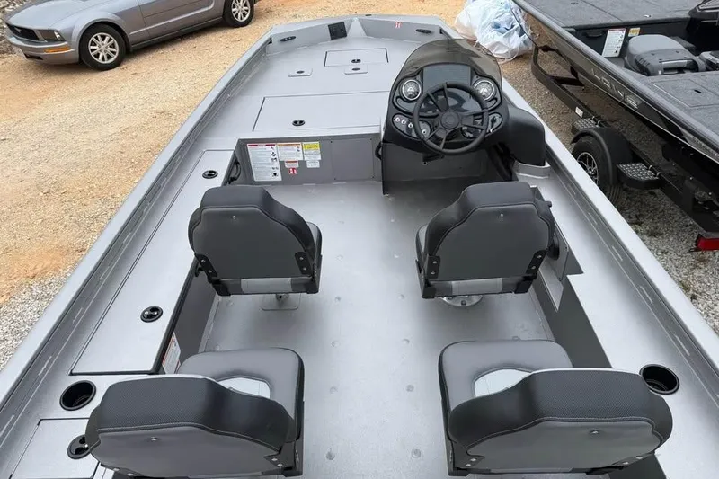 Slide: The Image of 2026 Lowe Outlet 20 boat interior with four seats and steering console. - 9