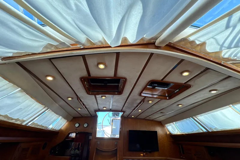 Slide: The Image of Interior view of 2001 North Wind 56 yacht with elegant wood paneling and ceiling lights. - 18