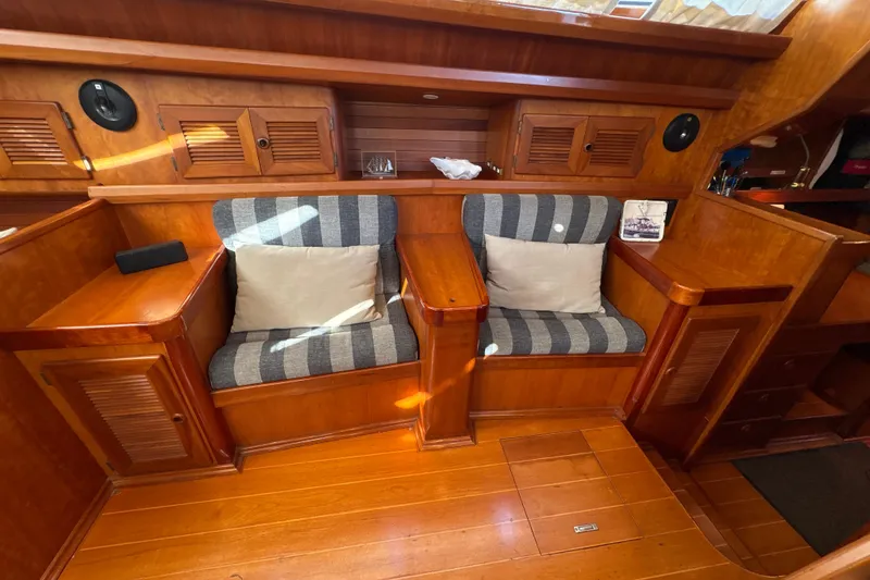 Slide: The Image of Luxurious wooden interior of 2001 North Wind 56 yacht with striped seating. - 19