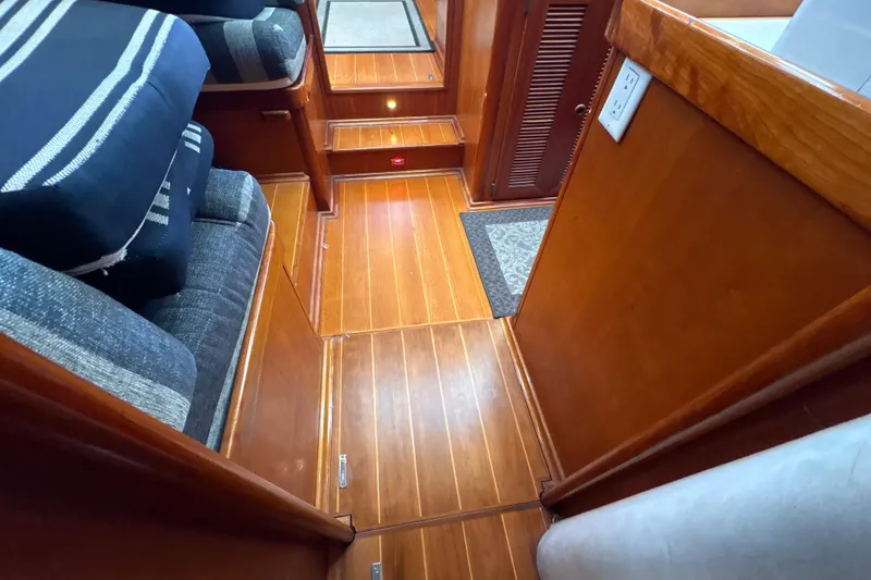 Slide: The Image of Interior of 2001 North Wind 56 yacht with wooden flooring and striped cushions. - 20