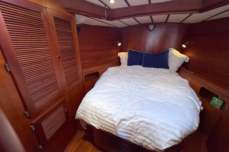 Slide: The Image of Cozy cabin bedroom in 2001 North Wind 56 yacht with wooden interior and comfortable bedding. - 23