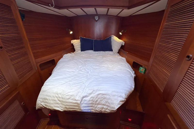 Slide: The Image of Cozy cabin bedroom in 2001 North Wind 56 yacht with wooden interior and comfortable bedding. - 24