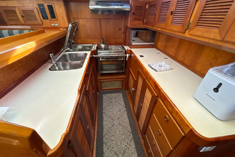 Slide: The Image of Luxurious wooden yacht kitchen interior, North Wind 56, 2001 model, featuring modern appliances. - 25