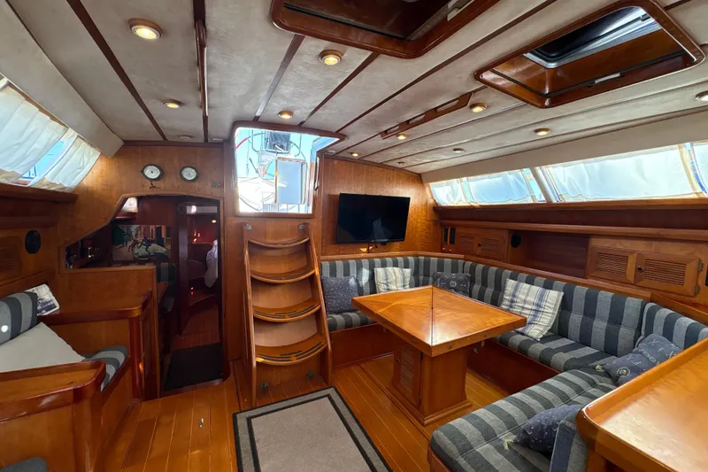 Slide: The Image of Luxurious 2001 North Wind 56 yacht interior with wood finish and cozy seating area. - 27