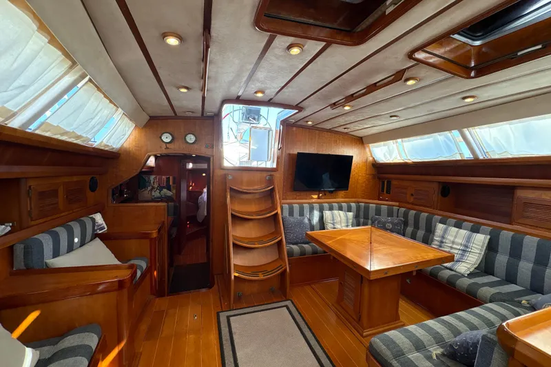 Slide: The Image of Luxurious interior of 2001 North Wind 56 yacht with wood finish and cozy seating area. - 28