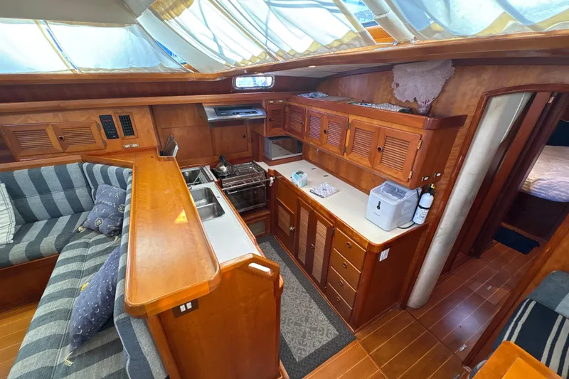 Slide: The Image of Luxurious 2001 North Wind 56 yacht interior with wood cabinetry and cozy seating area. - 30