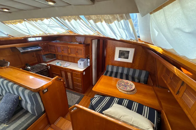 Slide: The Image of Luxurious interior of a 2001 North Wind 56 yacht with wood finishes and cozy seating. - 31