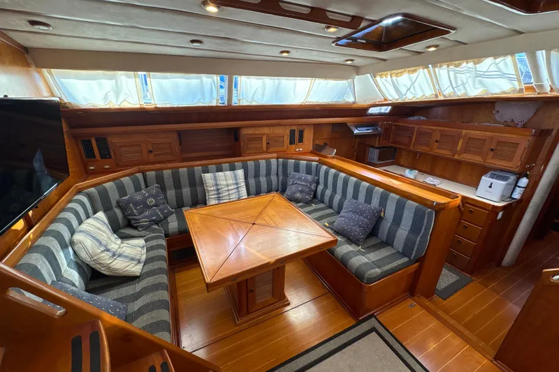 Slide: The Image of Luxurious interior of 2001 North Wind 56 yacht with cozy seating and wooden finishes. - 32