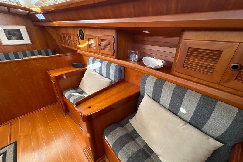 Slide: The Image of Luxurious wooden interior of 2001 North Wind 56 yacht with striped seating and decor. - 33