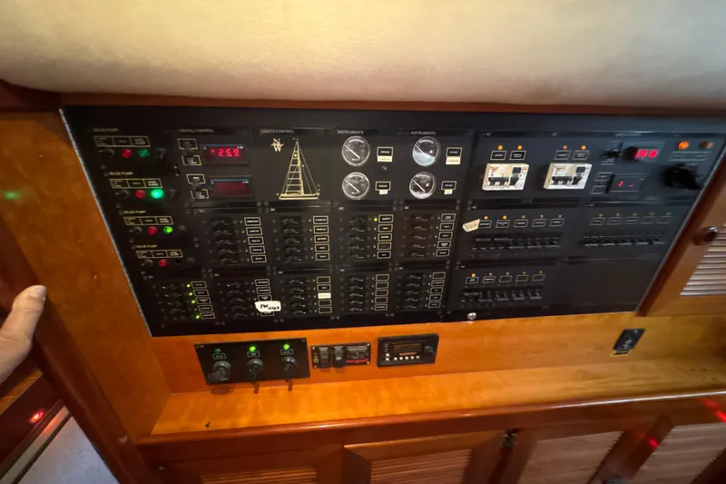 Slide: The Image of Control panel of a 2001 North Wind 56 yacht, featuring various switches and gauges. - 35