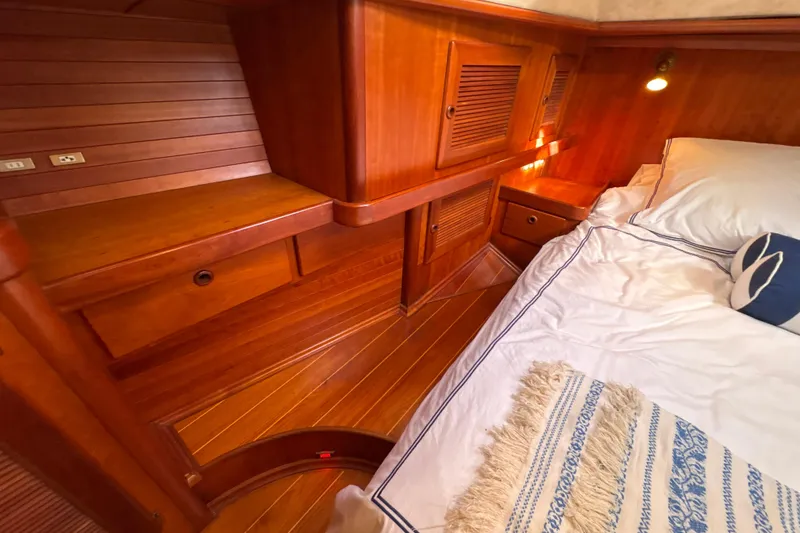 Slide: The Image of Luxurious wooden cabin interior of a 2001 North Wind 56 yacht, featuring cozy bedding. - 38