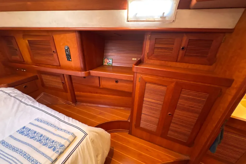 Slide: The Image of Luxurious wooden cabin interior of 2001 North Wind 56 yacht with bed and storage. - 40