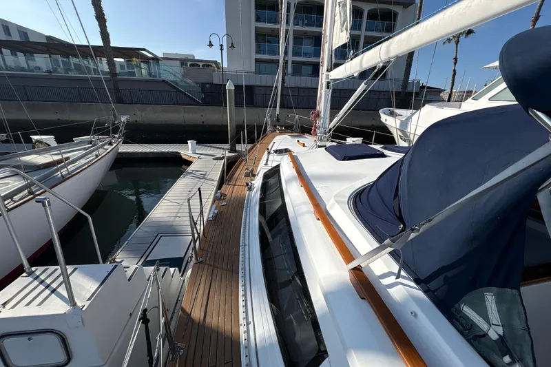 Slide: The Image of Sailboat docked at marina, North Wind 56, 2001 model, with wooden deck and blue cover. - 8