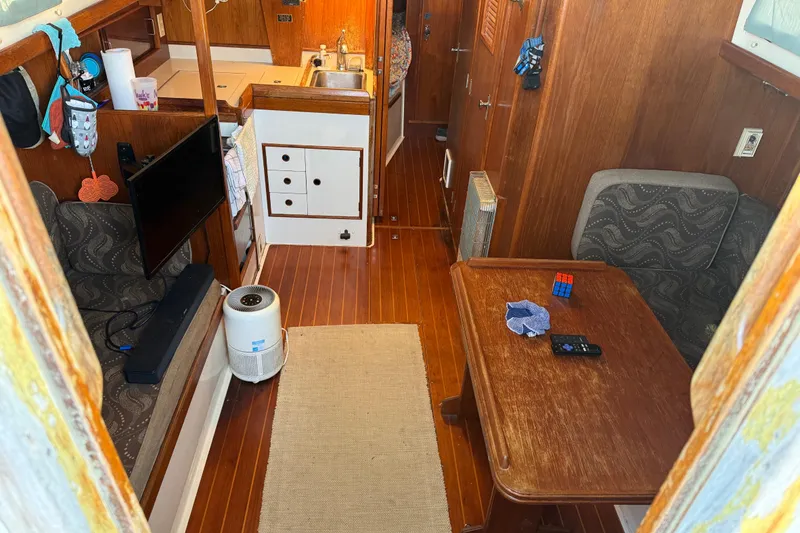 Slide: The Image of Interior of 1989 Nonsuch 30 Ultra sailboat with cozy seating and wooden finishes. - 10
