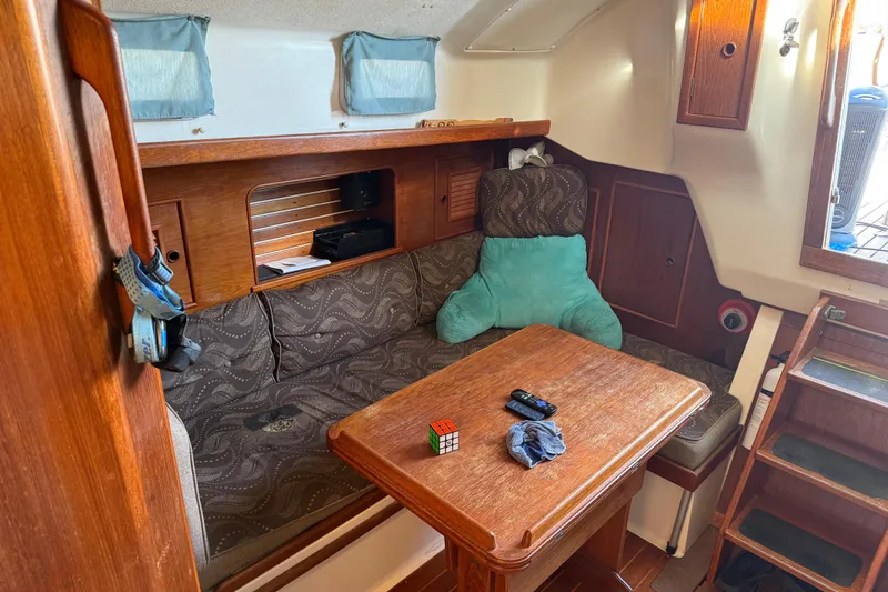 Slide: The Image of Cozy interior of 1989 Nonsuch 30 Ultra sailboat with wooden table and seating area. - 11
