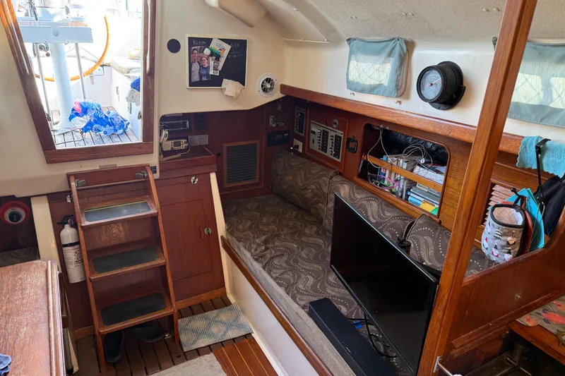 Slide: The Image of Interior of 1989 Nonsuch 30 Ultra sailboat with cozy seating and wooden accents. - 12