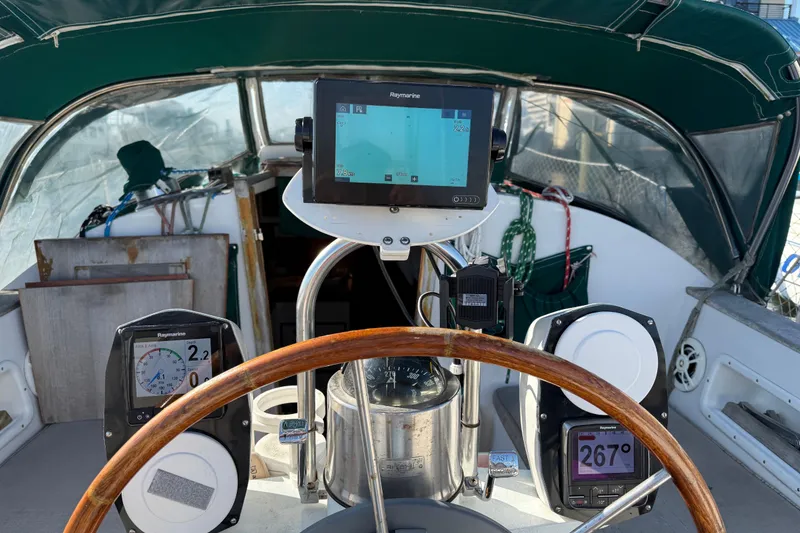 Slide: The Image of Cockpit of 1989 Nonsuch 30 Ultra sailboat with navigation instruments and wooden steering wheel. - 15