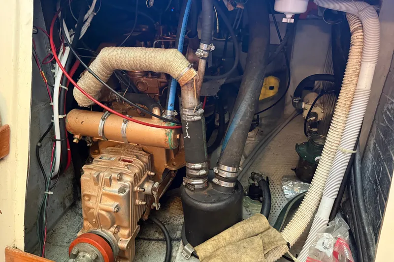 Slide: The Image of Engine compartment of a 1989 Nonsuch 30 Ultra sailboat, showing mechanical components and wiring. - 22