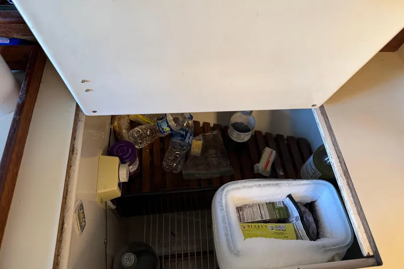 Slide: The Image of Open fridge on 1989 Nonsuch 30 Ultra sailboat with drinks and frozen food. - 24