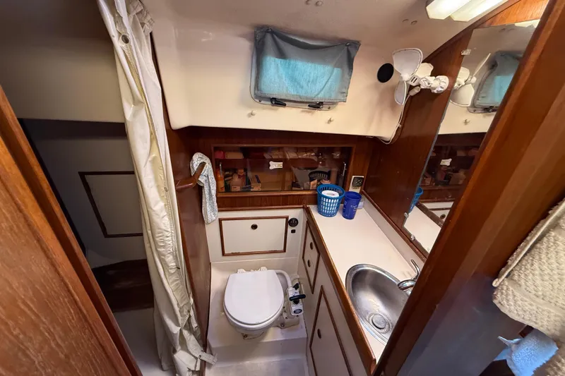 Slide: The Image of 1989 Nonsuch 30 Ultra yacht bathroom with sink, toilet, and storage. - 27