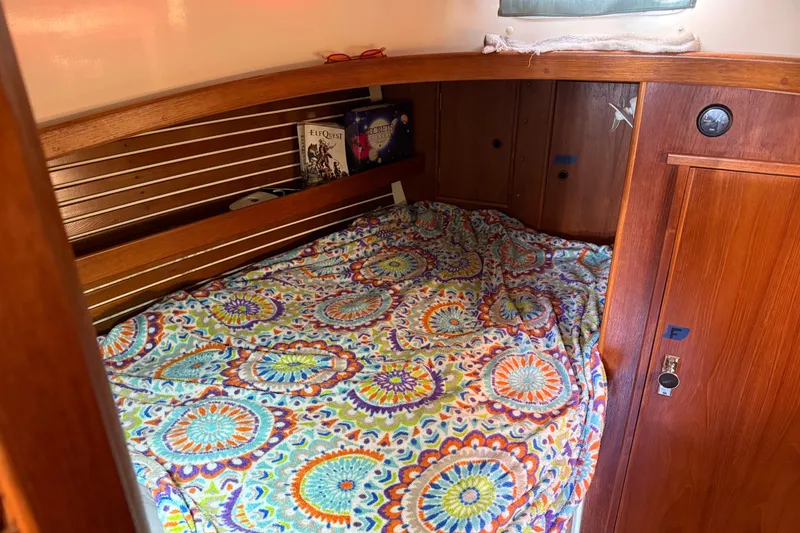Slide: The Image of Cozy cabin interior of 1989 Nonsuch 30 Ultra with colorful bedding and wooden accents. - 28
