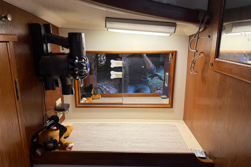 Slide: The Image of Interior of 1989 Nonsuch 30 Ultra sailboat with mirror, vacuum, and plush toy. - 29