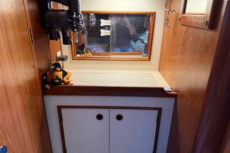 Slide: The Image of Cozy interior of 1989 Nonsuch 30 Ultra sailboat with wooden cabinetry and mirror. - 30