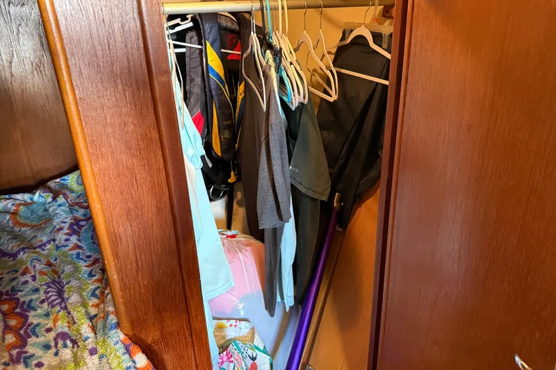 Slide: The Image of Wooden closet with clothes and hangers inside a 1989 Nonsuch 30 Ultra boat. - 31