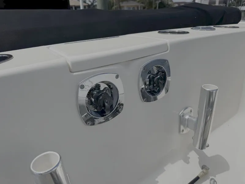 Slide: The Image of 2004 Intrepid 32 Cuddy boat deck with chrome fittings and rod holders. - 13