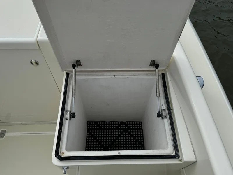 Slide: The Image of Open storage compartment on a 2004 Intrepid 32 Cuddy boat. - 16